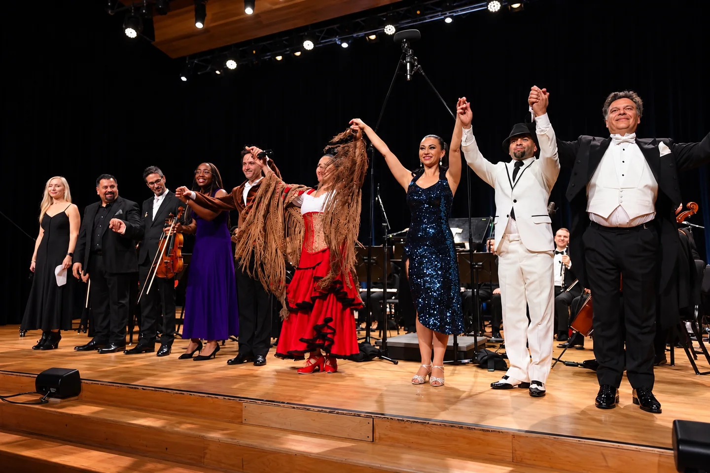 Daniel and fellow performers acknowledging the audience at the end of a stage performance.
